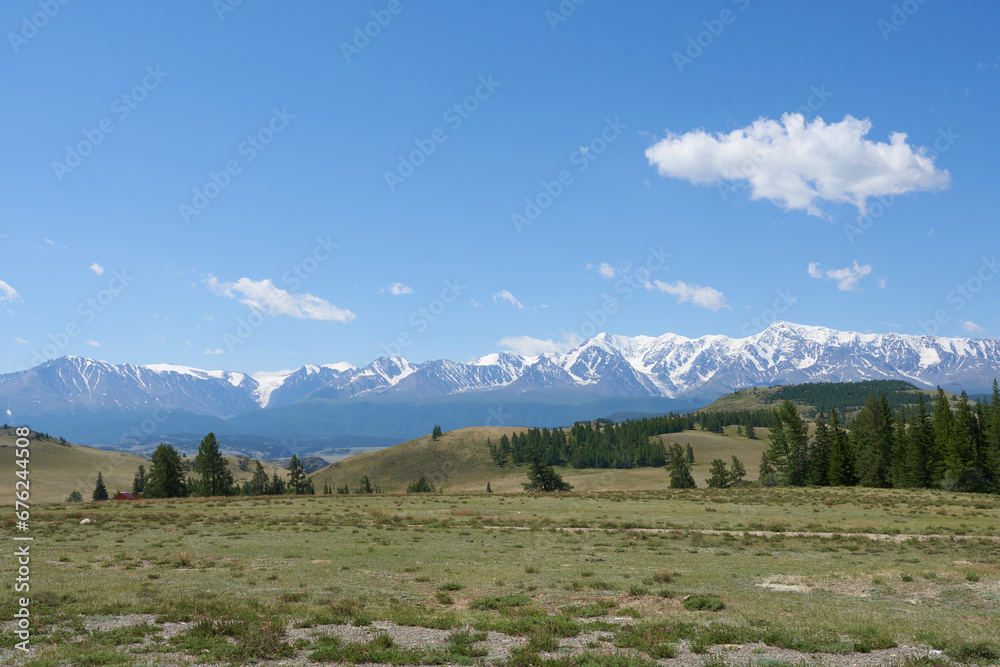Panaramic view of snow-capped mountain tops. Mountain Altai. Beautiful nature wallpaper.