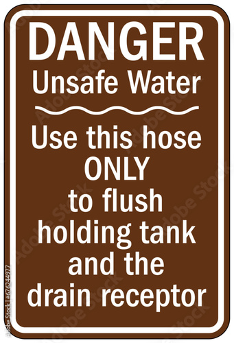 Dump station sign unsafe water use this hose only to flush holding tank and the drain receptor