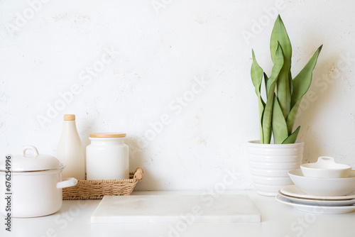 Marble podium on kitchen table with copy space and various kitchenware around