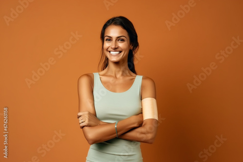 Woman, band aid on flex arm in power, strength or support of Australian hospital injection, Happy smile portrait of patient and plaster in global virus security or safety wellness