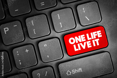 One Life Live It text button on keyboard, concept background photo