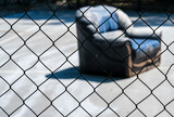 Blue couch, sofa, behind grid black fence. Sunny day. Jail time, concept. 