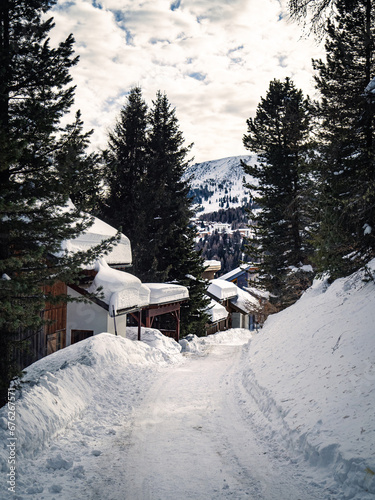 Empty snow covered street in a ski resort village with chalets in Carinthia © MatyasSipos