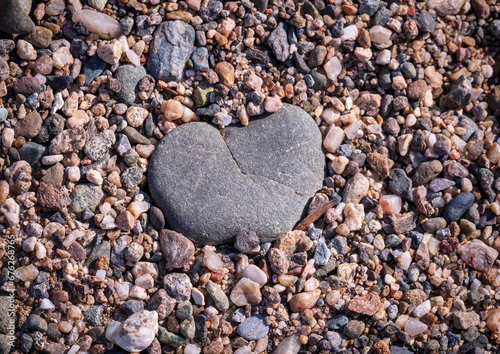 Heart shaped stone, sand beach surface with many stones. Amazing landscape. From nature with love. Heart shaped stone, sand beach surface with many stones. Amazing landscape. From nature with love.