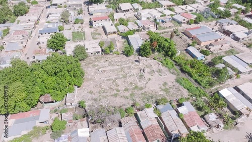 Aerial top down shot of poor neighborhood and tomb in PUEBLO VIEJO AZUA, Dominican Republic  - Tilt up shot 