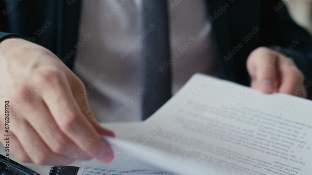 Close up stab shot of hand of unrecognizable male office worker in suit stapling documents with stapler in office Close up stab shot of hand of unrecognizable male office worker in suit stapling documents with stapler in office