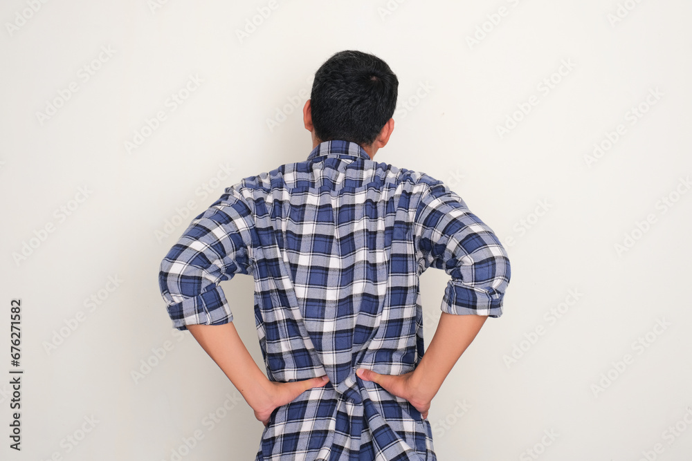 Back view of a man suffering low back pain Back view of a man suffering low back pain