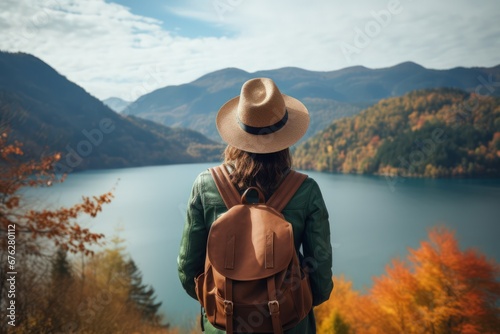Young female tourist looking at beautiful autumn scenery landscape