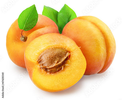 Ripe apricots with green leaves and apricot half isolated on white background. File contains clipping path.