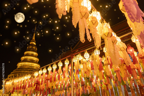Lantern Festival in Lamphun people hang colorful light lanterns at Wat Phra That Hariphunchai Temple full moon photo