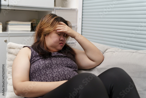 Sad Overweight plus size woman thinking about problems on sofa upset girl feeling lonely and sad from bad relationship or Depressed woman disorder mental health