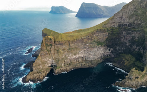 Gorgeous evening view from flying droneof Kallur Lighthouse, Kalsoy island. Spectacular summer scene of Faroe Islands, Denmark, Europe. Great seascape of Atlantic ocean.