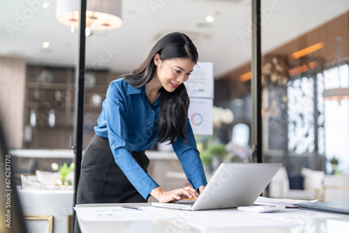 Beautiful Business Woman working by using laptop computer Hands typing on keyboard. Professional investor working new start up project. business planning in office. Technology business
