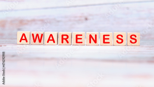 AWARENESS word made of wooden cubes on a light background