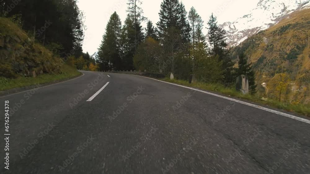 Car ride Point Of View, The Majestic Grossglockner Mountain Road in Austria, snow covered sharp peaks of the alpine mountains. POV shot of sport car or bicycle drives along the majestic and most Car ride Point Of View, The Majestic Grossglockner Mountain Road in Austria, snow covered sharp peaks of the alpine mountains. POV shot of sport car or bicycle drives along the majestic and most