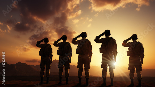 Military silhouettes of soldiers against the backdrop of sunset sky,Silhouette of soldiers,Concept - armed forces. © kiatipol