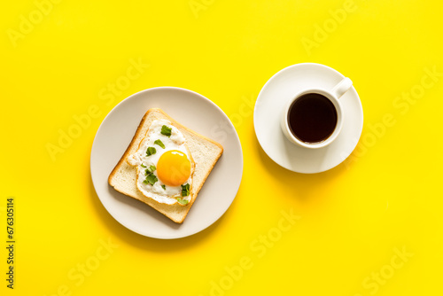 Breakfast with fried eggs on toast bread and cup of black coffee