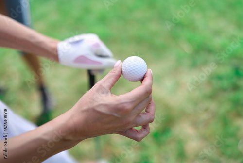 Closeup of golf balls in female hands. sport games concept