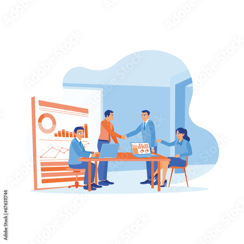 Male boss leading a meeting with another work team in the meeting room. Boss shaking hands and congratulating a coworker for good performance. New employees concept. 