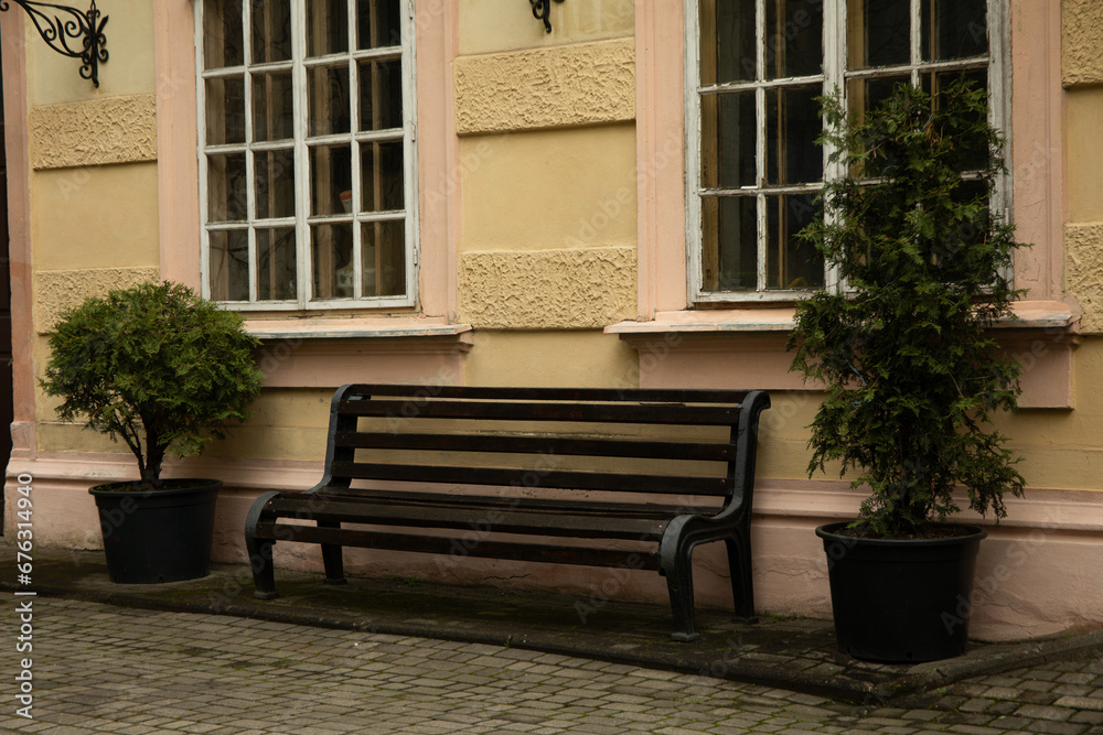 A beautiful bench near the wall of the house
