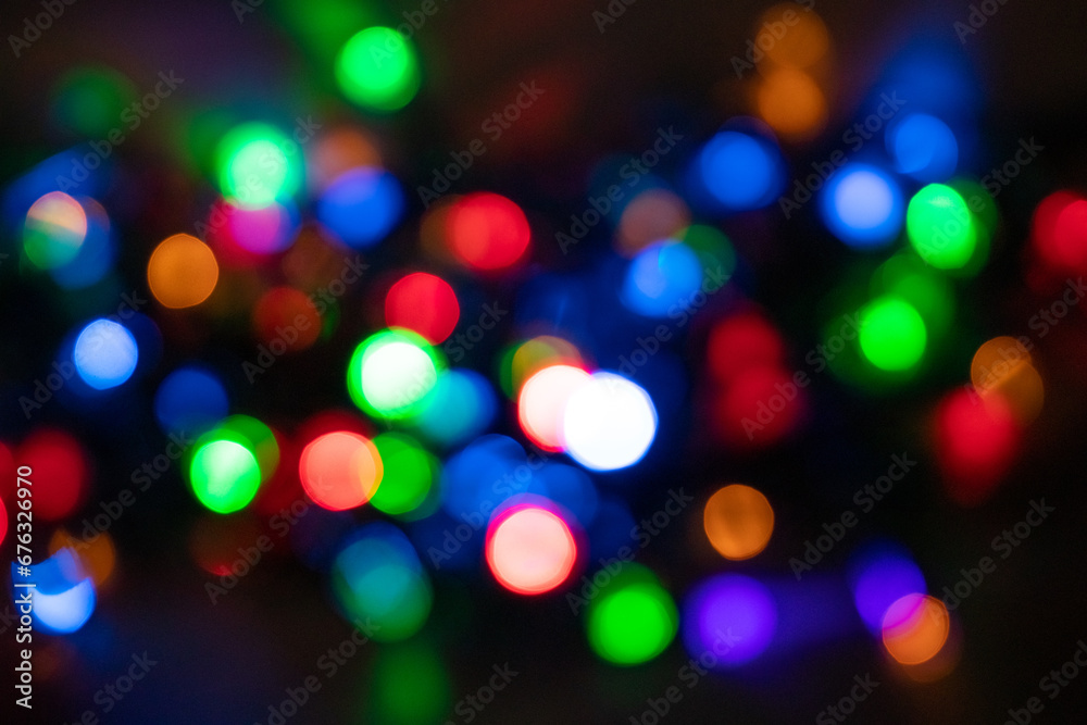 Festive Christmas and New Year background with bokeh, blurred lights on black background Festive Christmas and New Year background with bokeh, blurred lights on black background