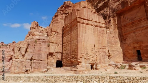 Panning shot of the ancient ruins of royal tombs carved in Petra Jordan photo