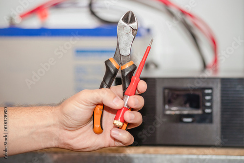 Wallpaper Mural Inverter Installing Service. Electrician Hand with Electrician Tools on Solar Inverter Background. Electrician Repairing Inverter. Electrical engineer Testing Inverter. Torontodigital.ca