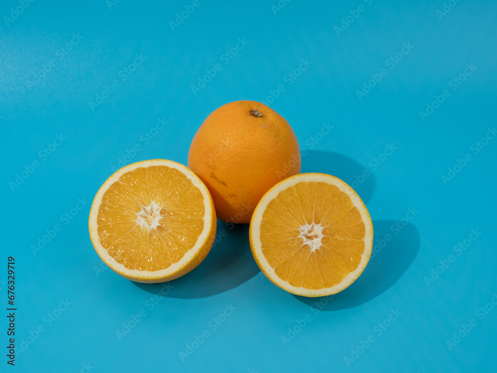 Ripe oranges on a blue background. Oranges on blue. Ripe oranges on a blue background. Oranges on blue.