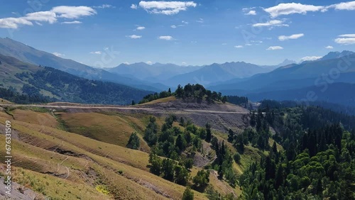 The Arkasara Plateau. Movement of white cumulus clouds over the Arcasara ridge on a sunny day against a bright blue sky. The pass from Arkhyz to Phia, Caucasus, Russia 4K photo