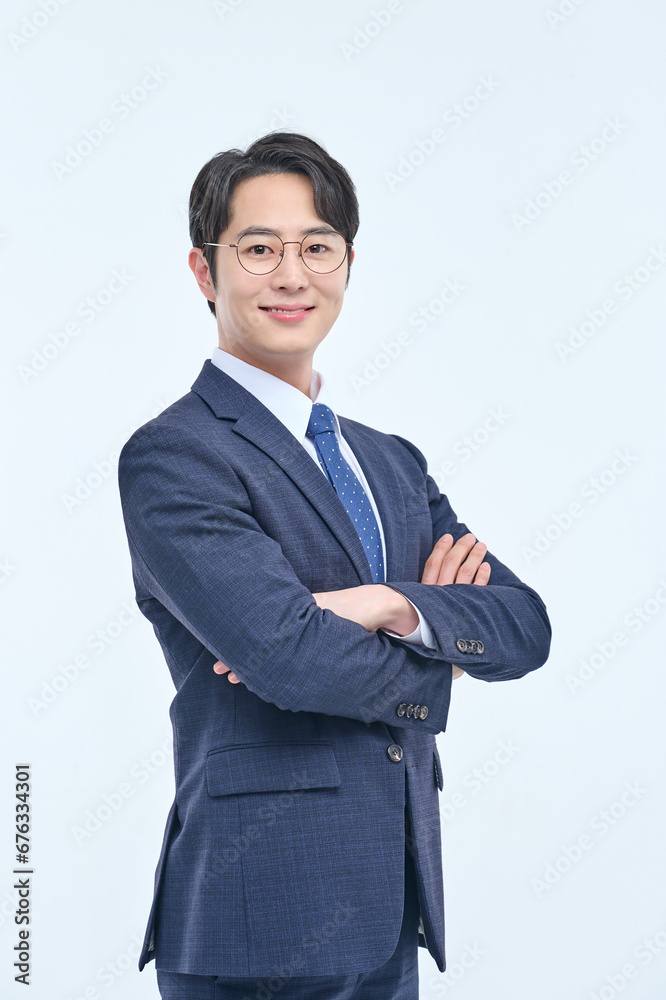 A young and handsome Asian man in a suit is wearing glasses and making various facial expressions and hand gestures. A young and handsome Asian man in a suit is wearing glasses and making various facial expressions and hand gestures.