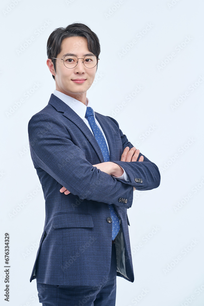 A young and handsome Asian man in a suit is wearing glasses and making various facial expressions and hand gestures.