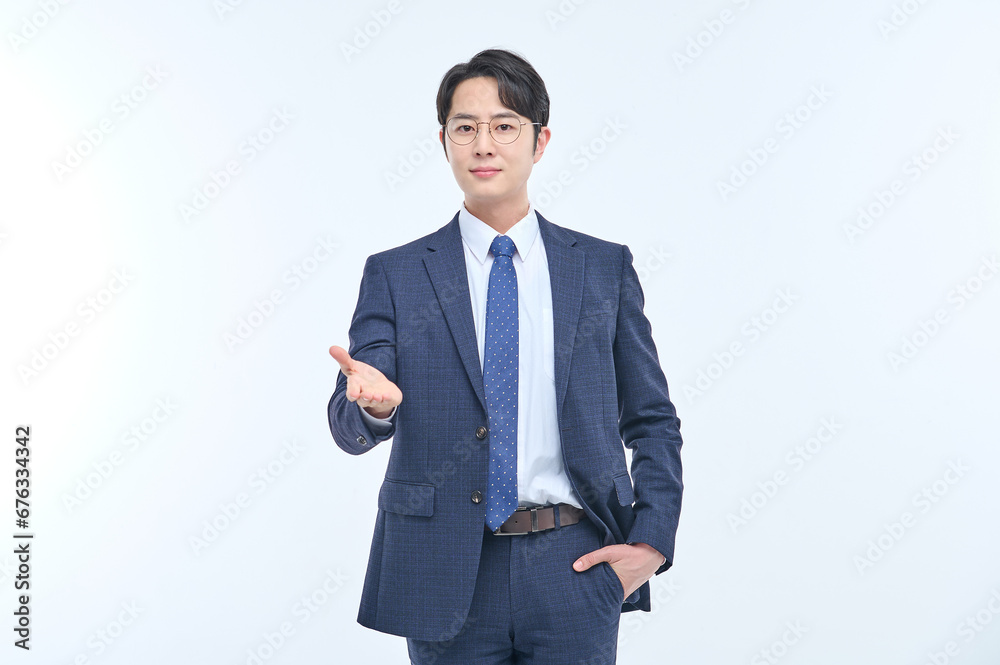 A young and handsome Asian man in a suit is wearing glasses and making various facial expressions and hand gestures. A young and handsome Asian man in a suit is wearing glasses and making various facial expressions and hand gestures.