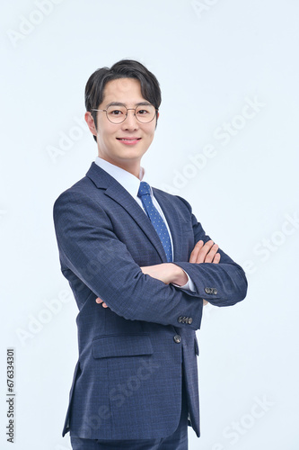 A young and handsome Asian man in a suit is wearing glasses and making various facial expressions and hand gestures.