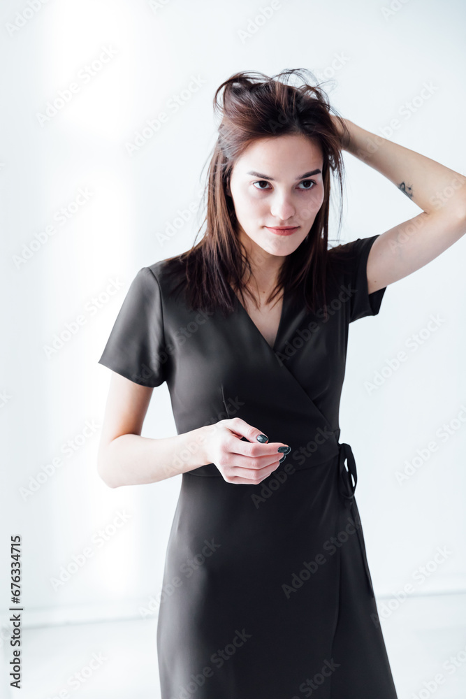 Fototapeta premium Beautiful brunette posing in bright room on white background