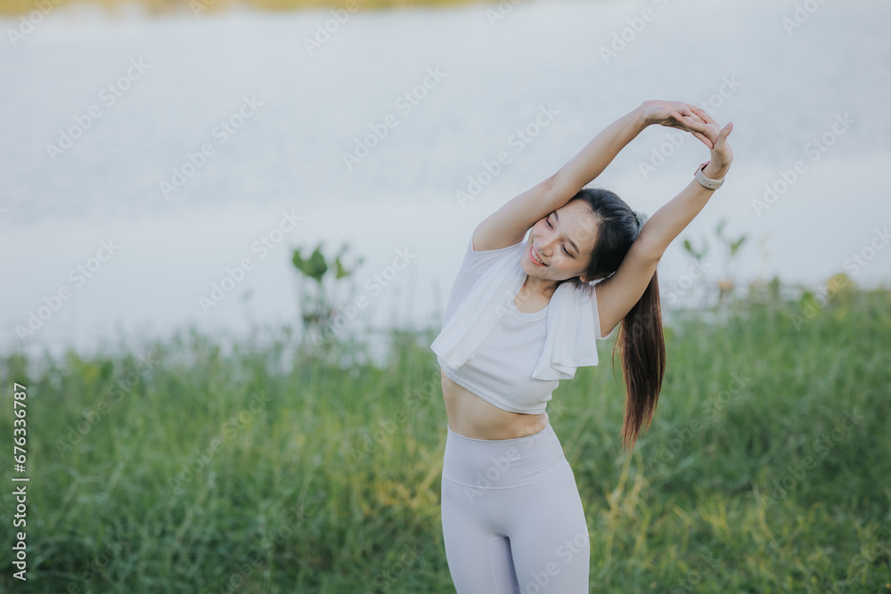 Portrait of a small, fit Asian woman exercising outside.