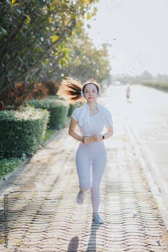 Happy petite Asian woman running at sunrise The concept of good health and exercise