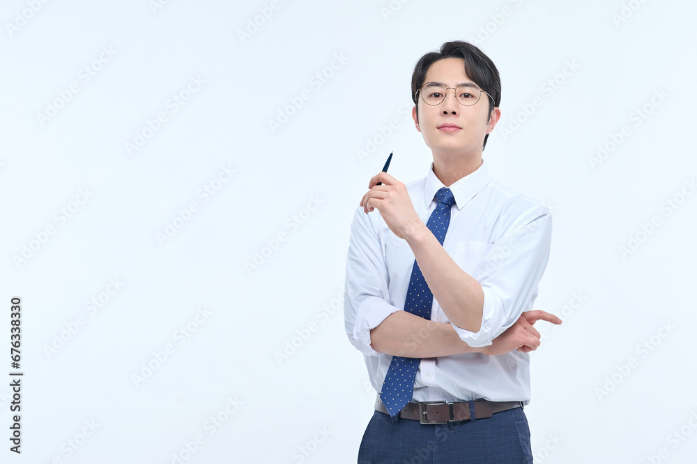 A young, handsome Asian man wearing glasses and a dress shirt and tie is holding a pen and explaining about business. A young, handsome Asian man wearing glasses and a dress shirt and tie is holding a pen and explaining about business.