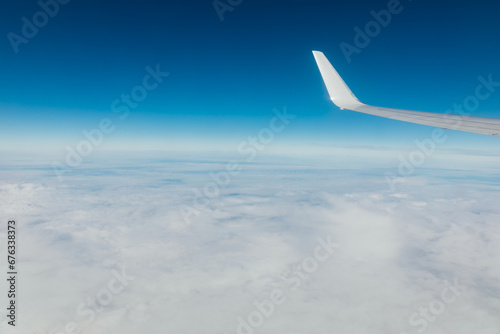 airplane wing in the sky with clouds travel flight