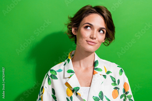 Photo of lovely cute dreamy girl wear trendy clothes looking empty space interesting offer isolated on green color background © deagreez