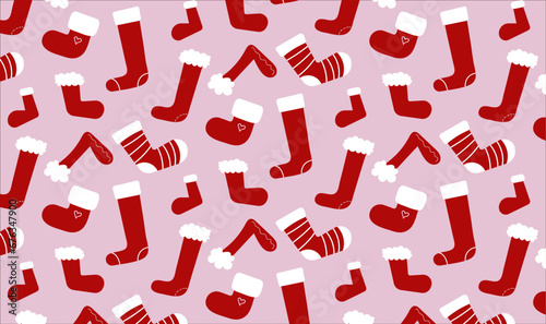 seamless vector pattern with stockings on pink background. cute cartoon repeating christmas pattern with red socks. new year holiday wallpaper or background