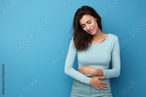 Woman suffering from abdominal pain. Woman stomach ache. Woman touching his stomach. Stomach pain and others stomach disease concept. photo