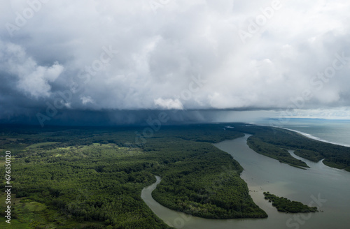 Storm front over meandering river and forest.