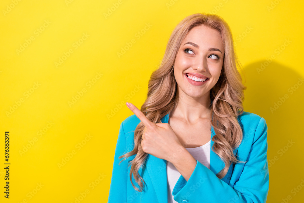 Portrait of cheerful gorgeous lady toothy smile look direct finger empty space isolated on yellow color background Portrait of cheerful gorgeous lady toothy smile look direct finger empty space isolated on yellow color background
