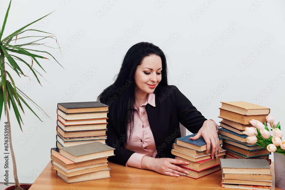 Female school librarian with books for university study Female school librarian with books for university study
