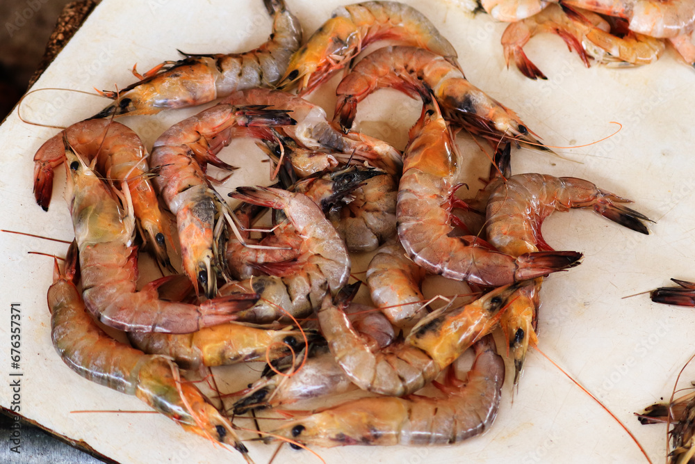 Close up - fresh red langoustine shrimps, prawns on local food market. Outdoor seafood, cookery, street food concept. view of seven very fresh spot prawns. royal red shrimp Close up - fresh red langoustine shrimps, prawns on local food market. Outdoor seafood, cookery, street food concept. view of seven very fresh spot prawns. royal red shrimp