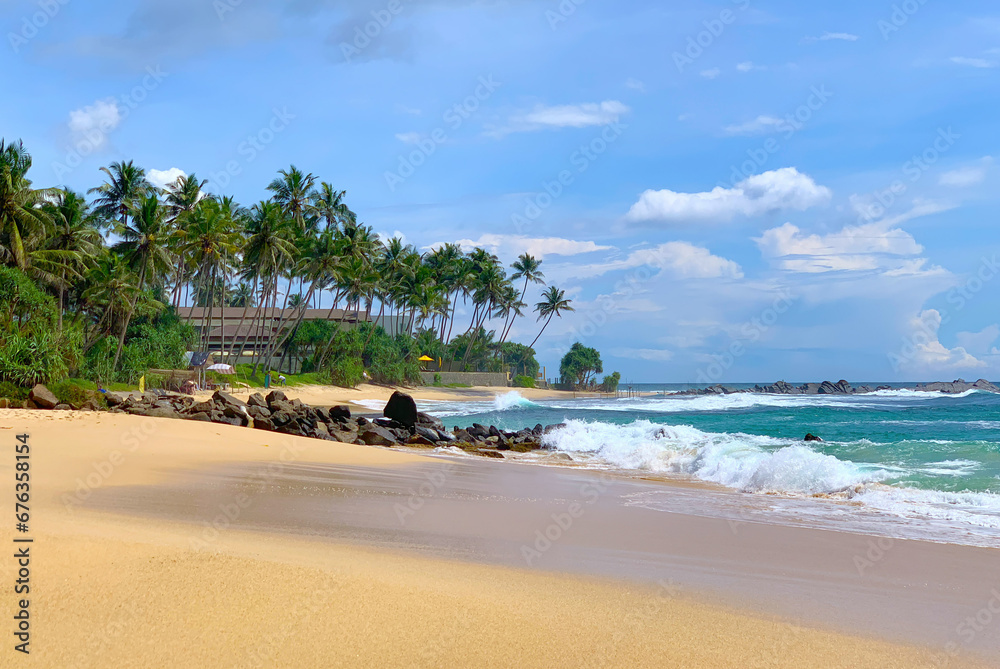 View of a beautiful sandy beach with palm trees, Indian Ocean coast in Sri Lanka, Unawatuna - obrazy, fototapety, plakaty 