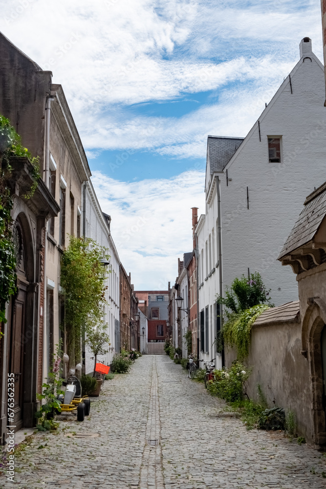 This serene image captures an empty cobblestone street in Mechelen's Groot Begijnhof. The quiet laneway, lined with historic architecture, offers a glimpse into the medieval charm of this Flemish city