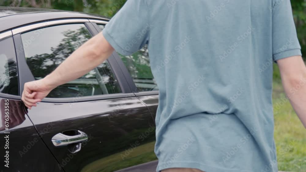 Medium side shot of male passenger getting out of taxi cab in parking zone Medium side shot of male passenger getting out of taxi cab in parking zone