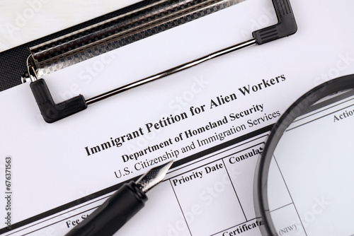 I-140 Immigrant petition for alien workers blank form on A4 tablet lies on office table with pen and magnifying glass close up photo