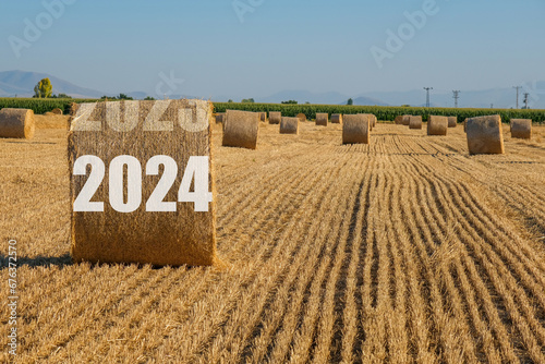Happy New Year 2024 agricultural business concept. View of bales in the field. photo